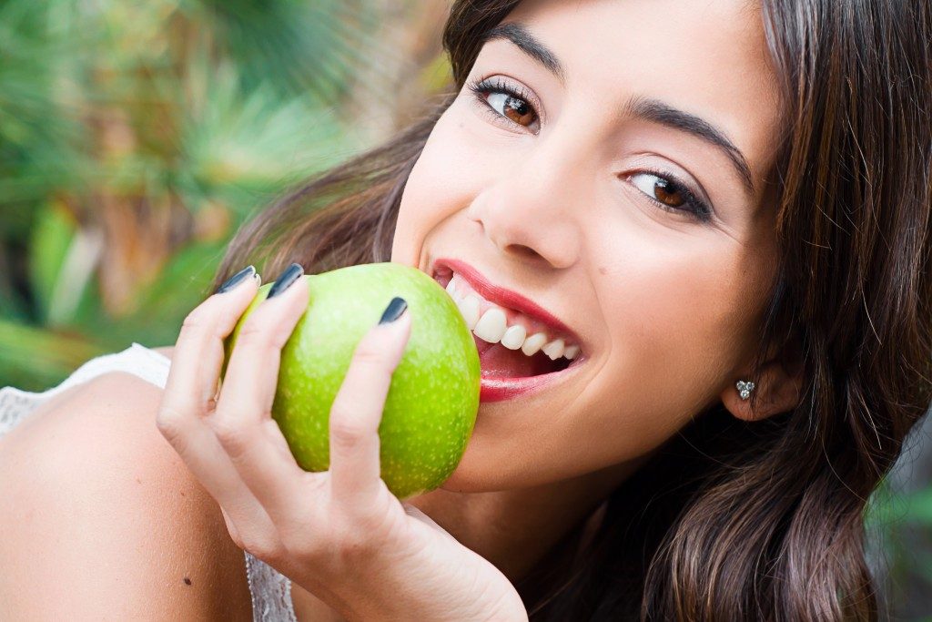 Teen biting an apple