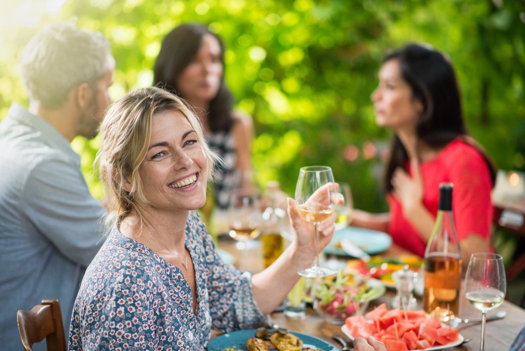Woman sharing meal with friends