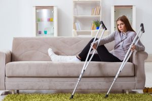 Young woman with injury and crutches
