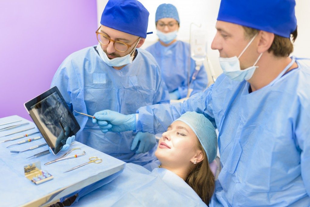 Dental team explaining to a patient