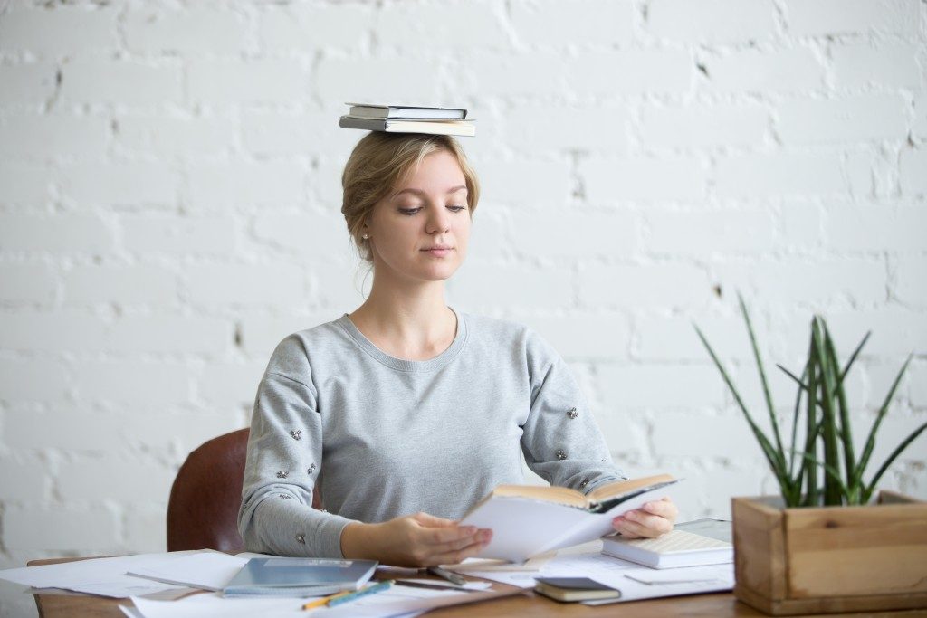 Woman with books on her head
