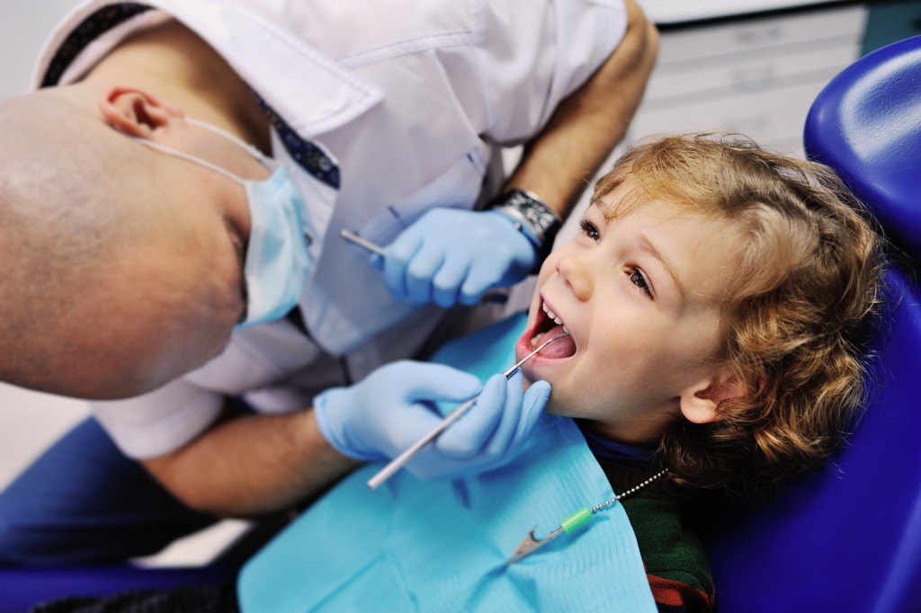 Dentist checking the child's teeth
