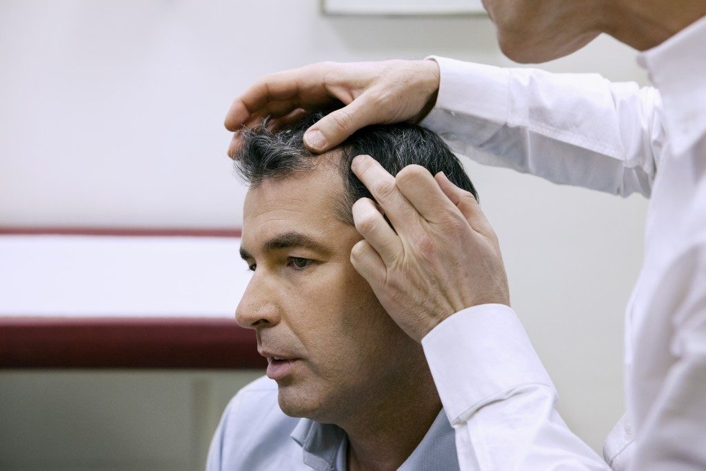 man's hair being checked
