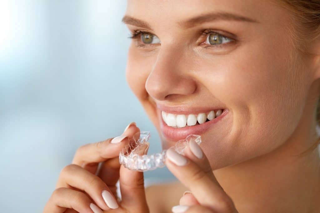 Woman about to wear invisalign