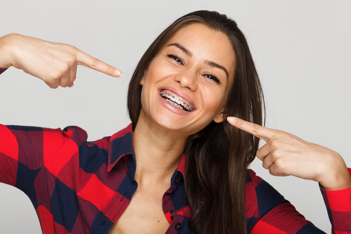 Woman pointing at her braces