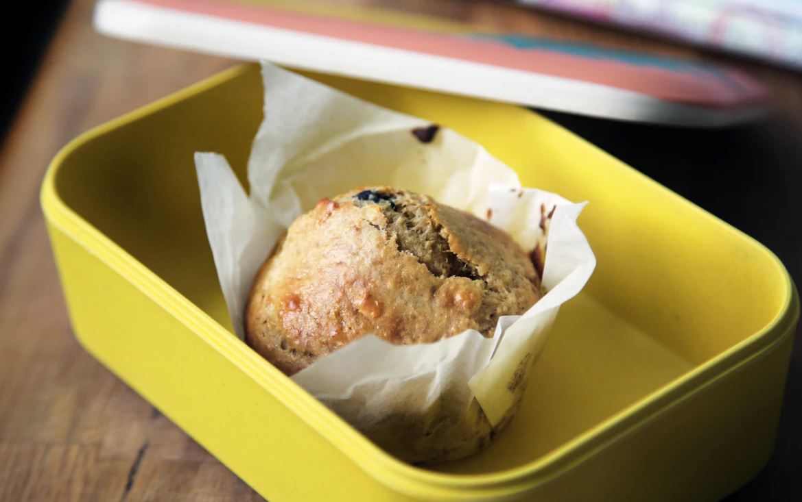 muffin on yellow plastic container