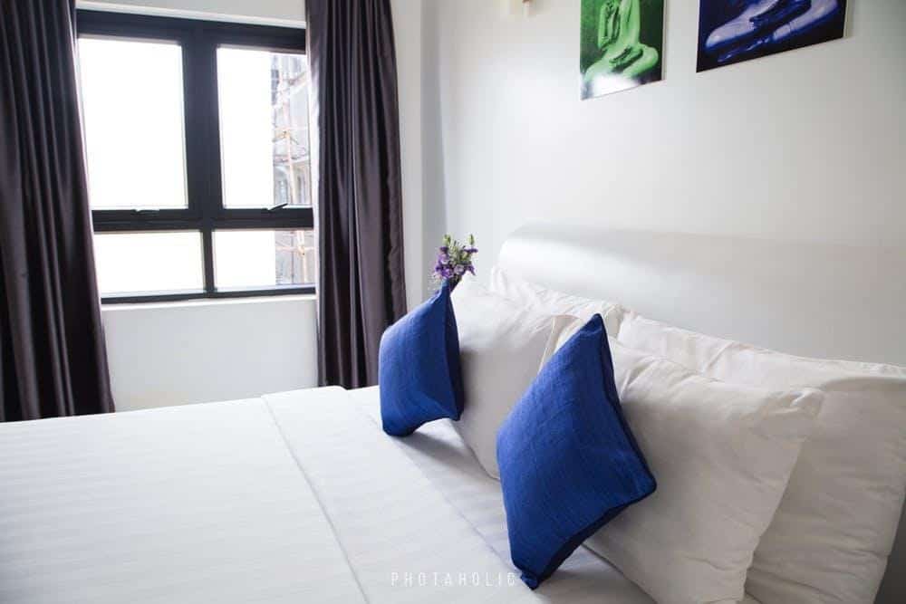 white bed with blue pillows