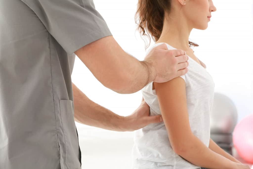 Chiropractor treating patient