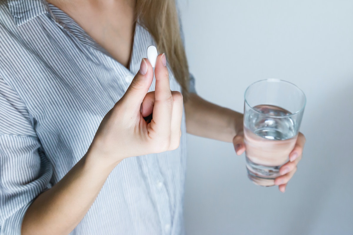 woman about to drink medicine