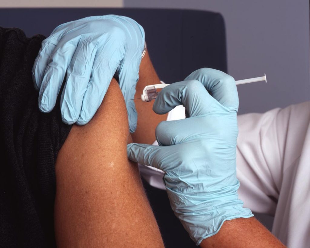 man taking a vaccine shot
