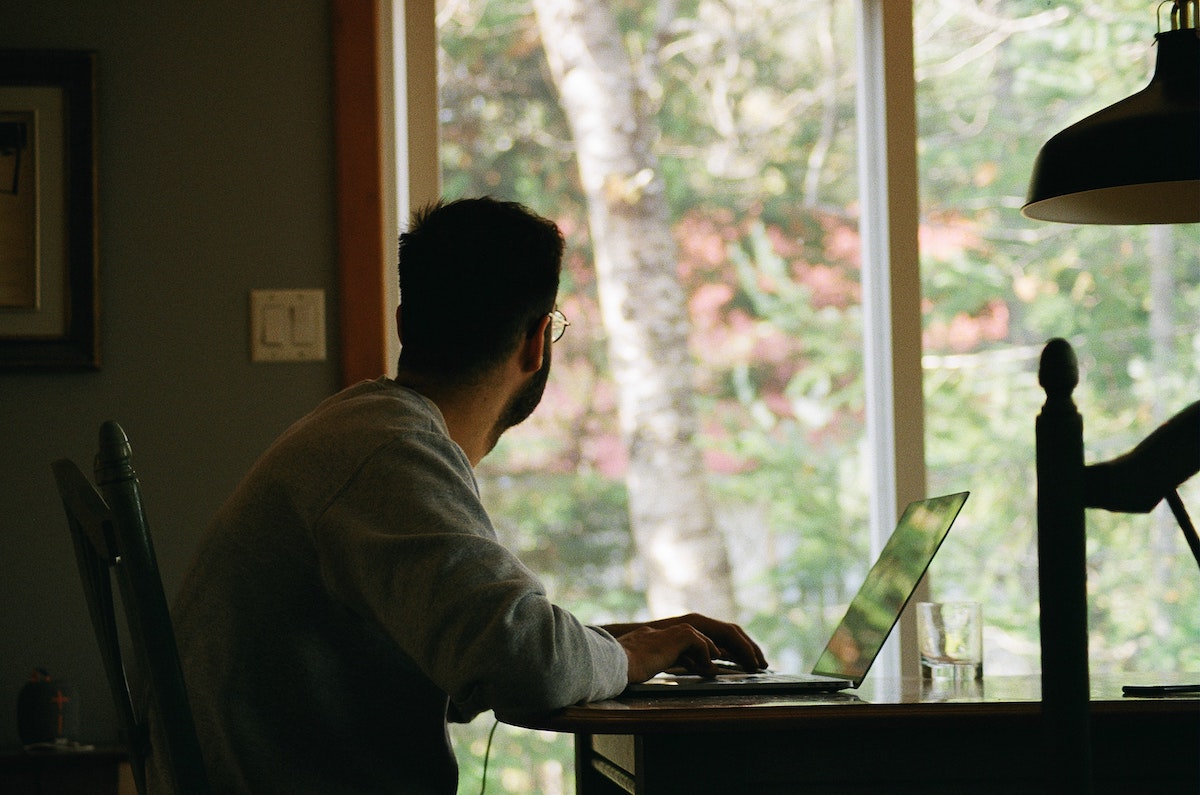 man looking out the window