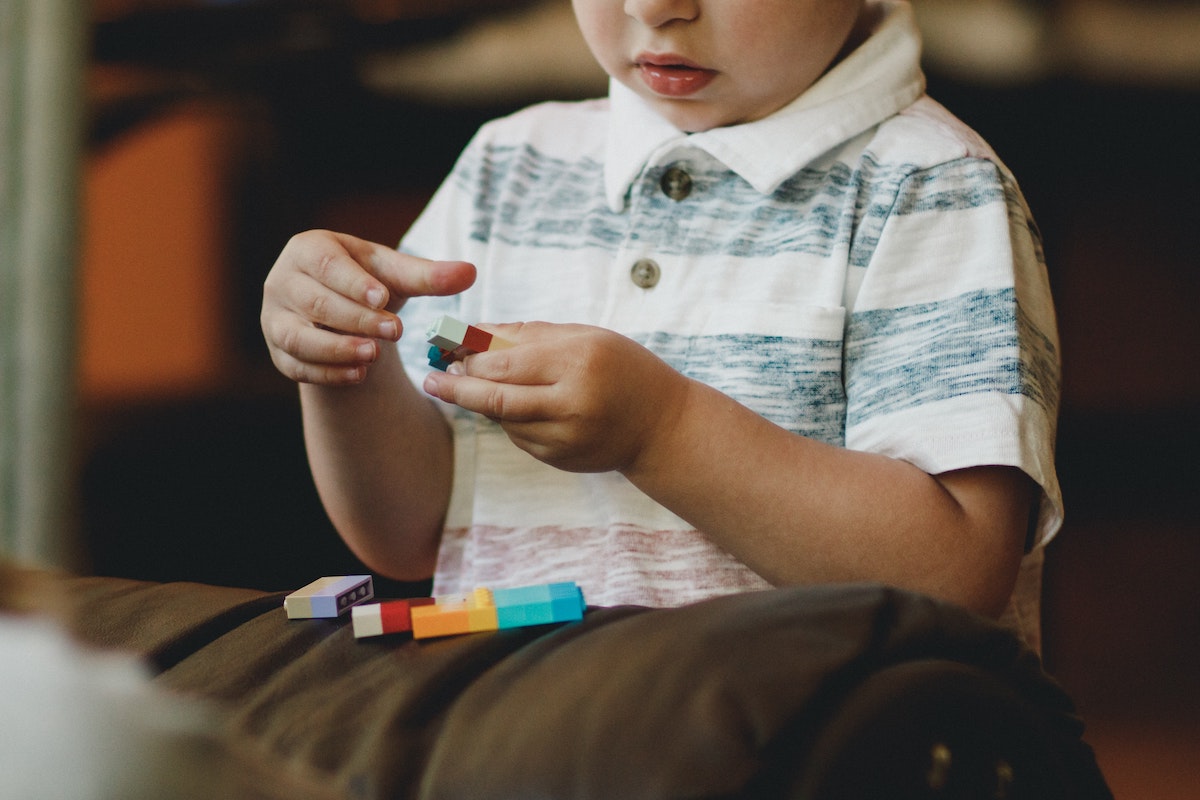 child holding small building blocks