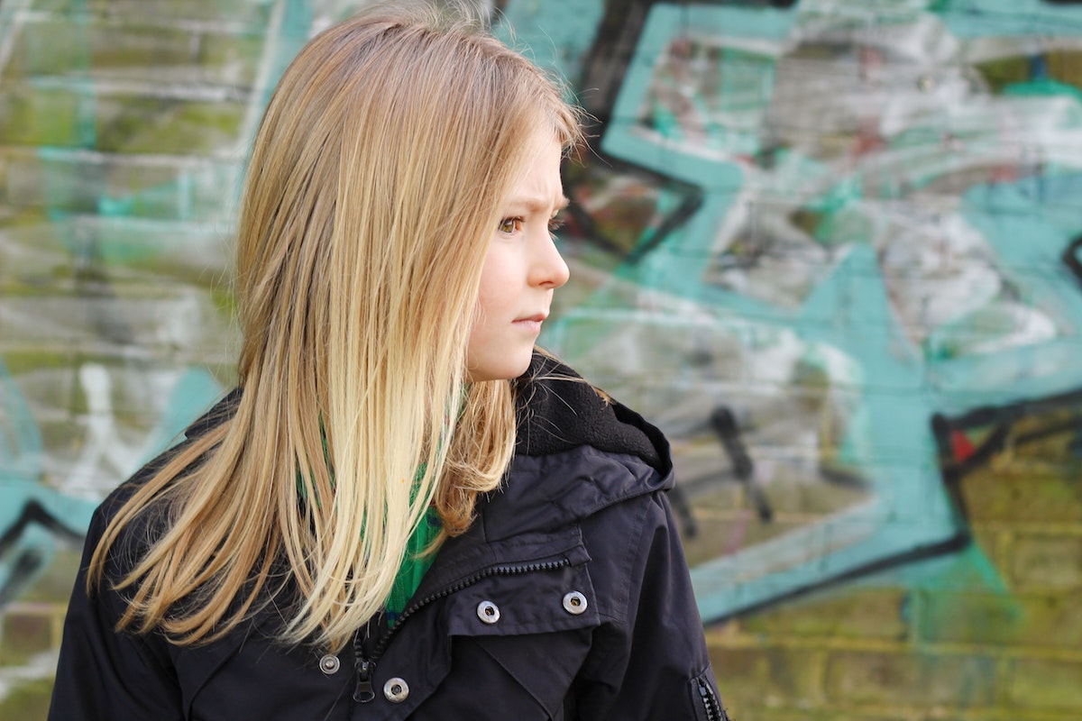 Bored little girl wearing a black jacket