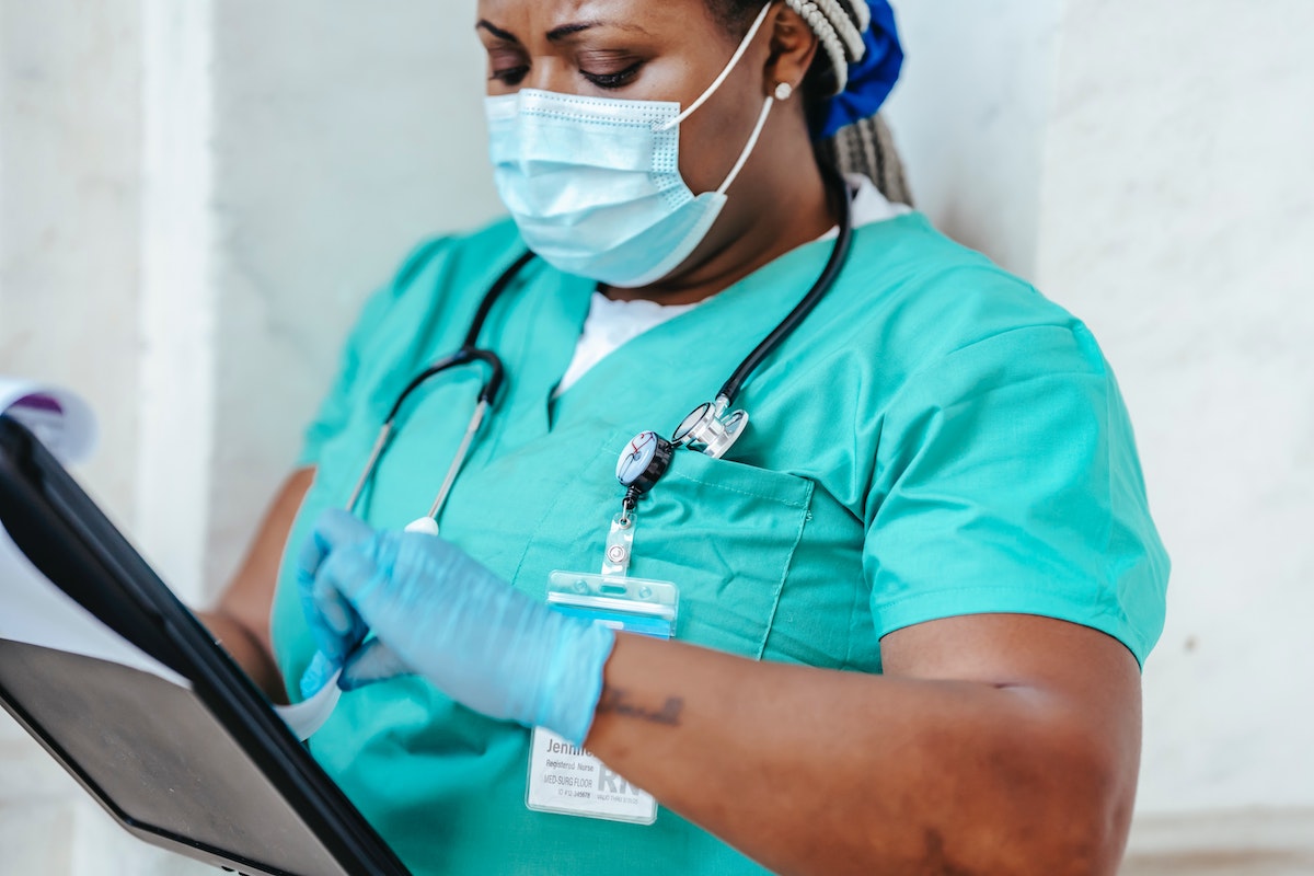 nurse checking patient board