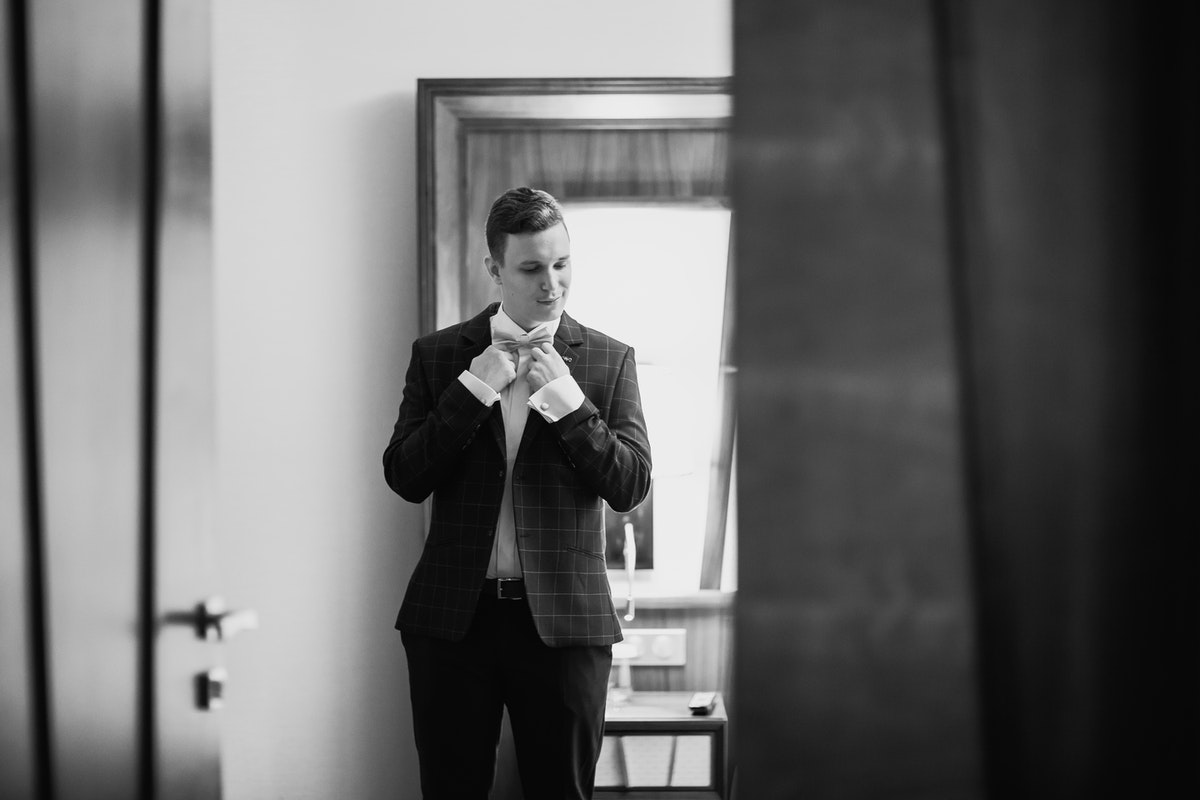 actor checking his bowtie