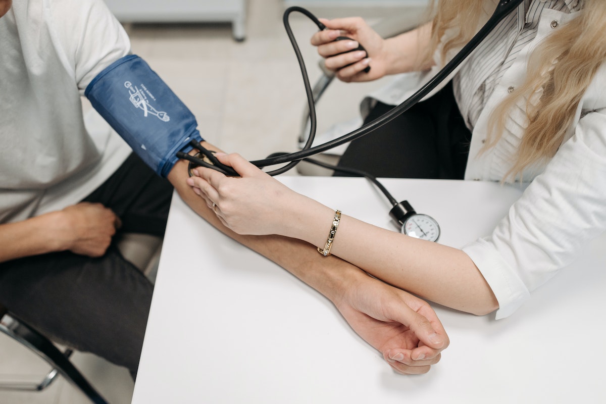 doctor getting a patient's blood pressure