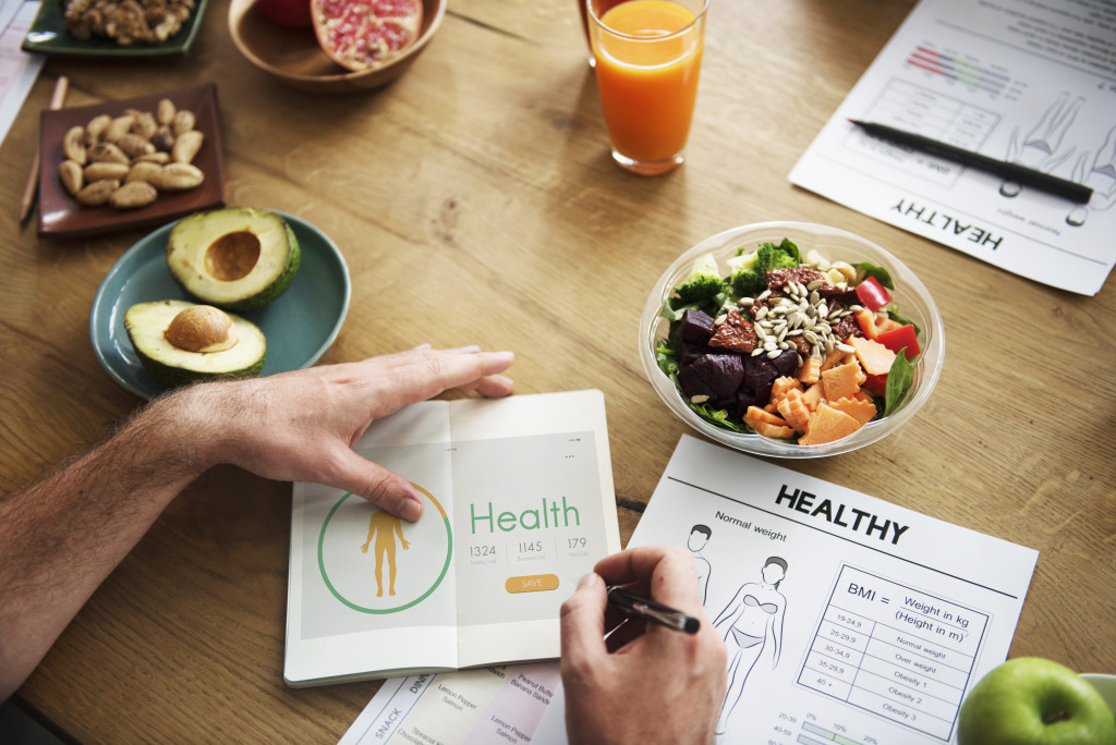 A person preparing a healthy meal using health charts