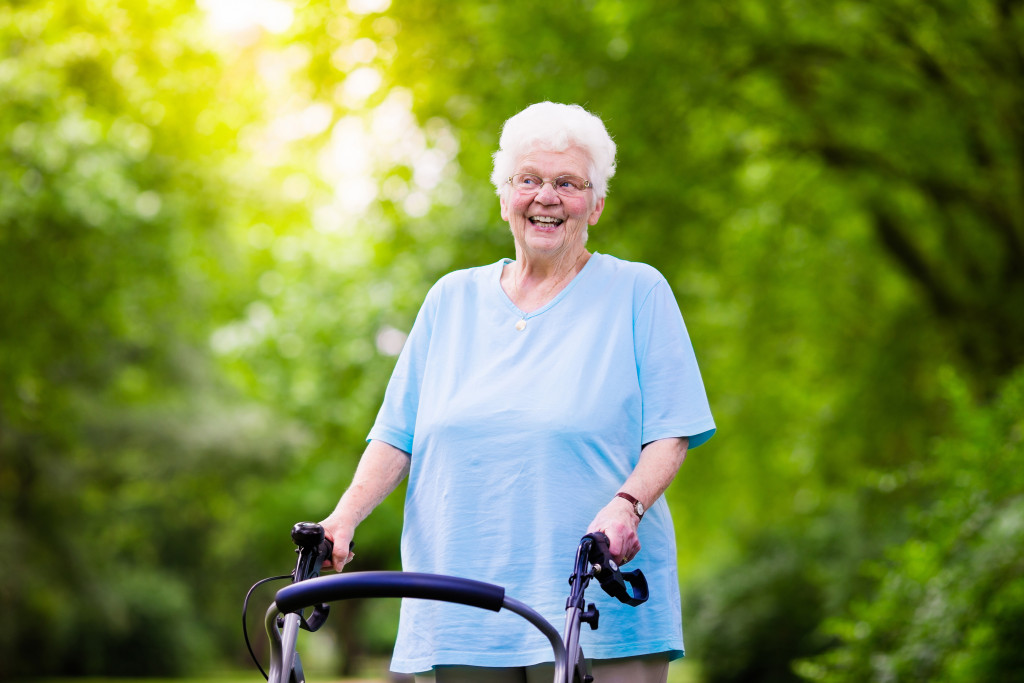 A senior woman outdoor walking with her walker