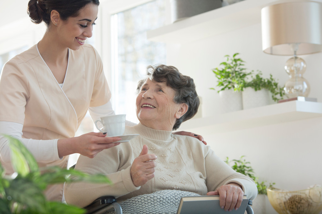 A caregiver looking after a senior woman