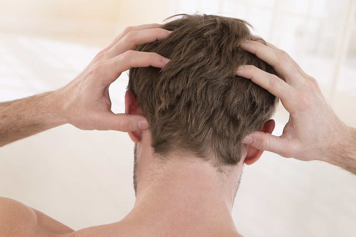 man suffering from itchy scalp