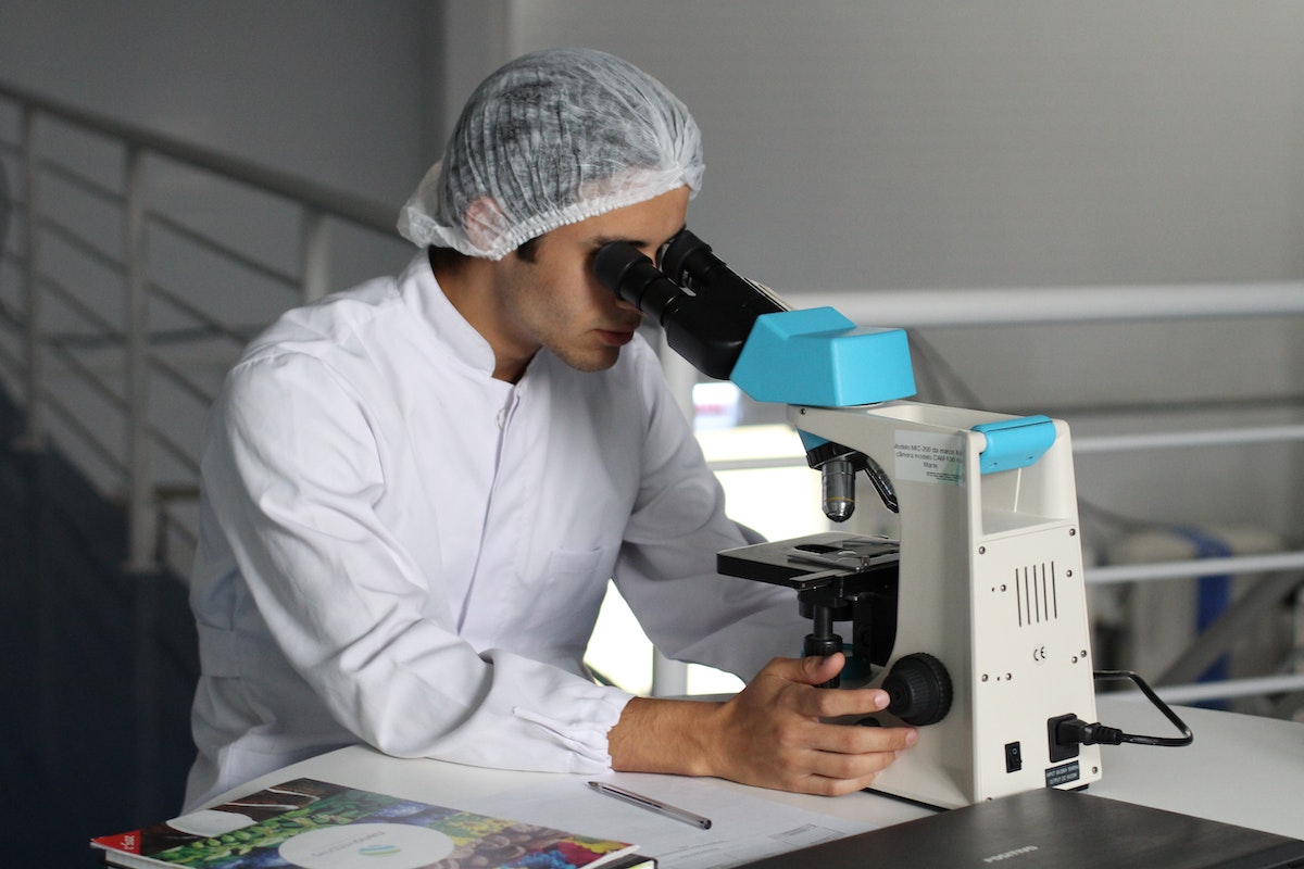student looking at a microscope