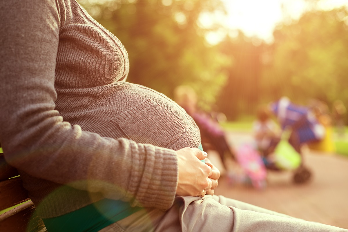 pregnant woman sitting at the bench