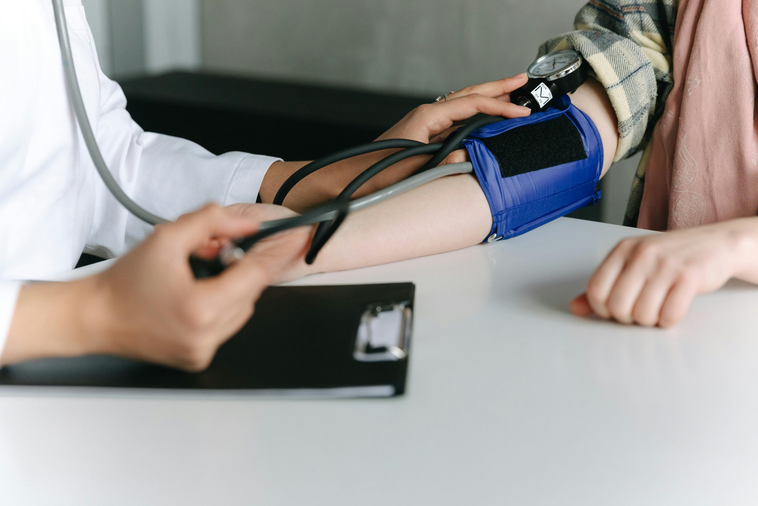doctor checking a patient's blood pressure